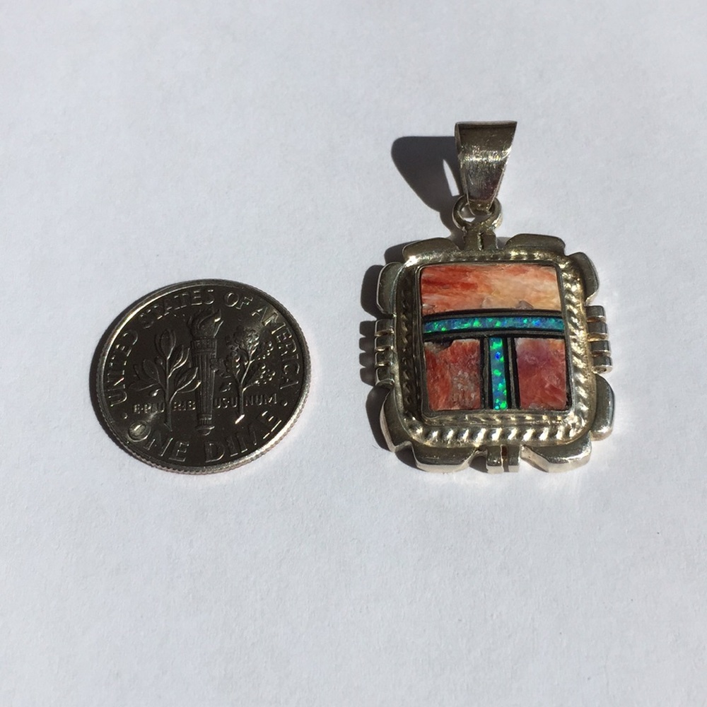 Sterling silver, opal and (unknown stone) pendant.